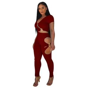 Close-up detail of a dark red two-piece set with sexy cut-outs and gold ring accents