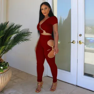 Full view of burgundy two-piece set showing unique cut-outs and metal ring connection details