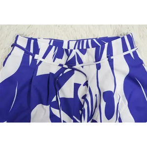 Close-up of the waist and drawstring detail on blue and white floral printed pants