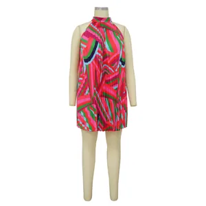 Front view detail of a vibrant geometric print pleated halter-neck mini dress