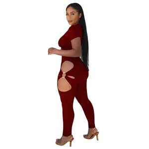 Side view of dark red two-piece short sleeve set with hip cutouts and ring details