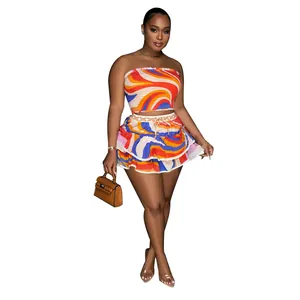 Vibrant abstract print two-piece set featuring a tube top and ruffled mini skirt.