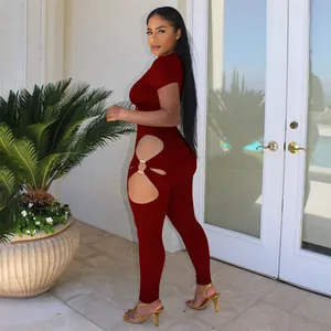 Sultry dark red short sleeve jumpsuit with decorative metal rings and side cutouts