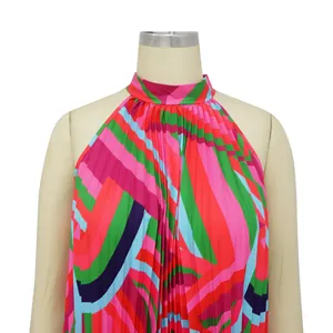 Close-up of the vibrant geometric print and fine pleats on this halter neck beach dress