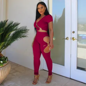 Two-piece set featuring V-neck short sleeve crop top and leggings with ring cut-outs.