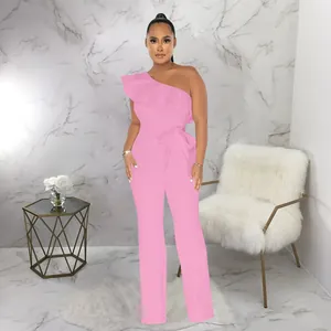 Detail view of stylish pink one-shoulder ruffle jumpsuit with a matching waist belt