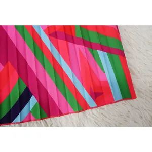 Macro detail shot of vibrant geometric printed fabric with elegant pleated texture design