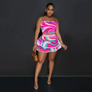 Vibrant abstract print two-piece set with strapless crop top and tiered mini skirt for summer.