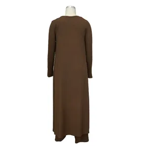Back view of dark brown three-piece ribbed knit set featuring long cardigan and pants.