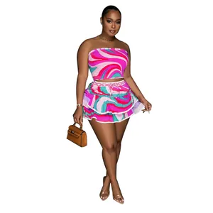 Vibrant two-piece skirt set with colorful abstract swirl print shown in a full-body model view