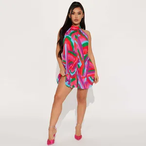 Detail view of colorful pleated halter neck dress with abstract print and mini length