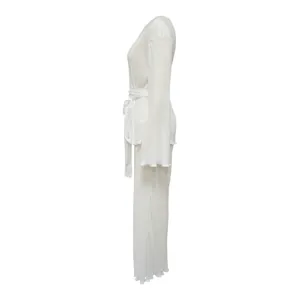 Side view of a white pleated two-piece loungewear set featuring long sleeves and tie waist.