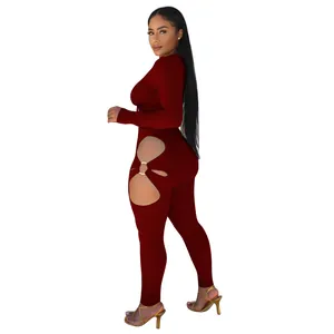 Maroon ribbed two-piece set featuring long sleeve top and cut-out leggings with ring detail