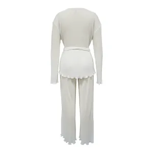 Back view of elegant white pleated two-piece set with long sleeves and belted waist