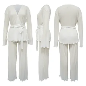 Three-way view of white pleated long sleeve casual set with waist tie and wavy hem