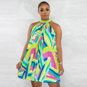 Detailed view of vibrant geometric pattern printed pleated halter mini dress on model