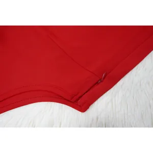 Close-up view of a red jumpsuit featuring a seamless invisible zipper detail