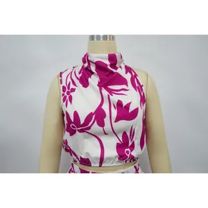 Detail of women's sleeveless high-neck top featuring magenta floral pattern design