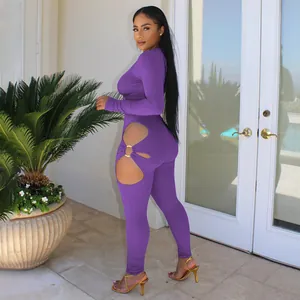 Detailed view of the purple ribbed jumpsuit featuring sexy side cut-outs and gold ring.