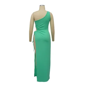 Back view of a green one-shoulder rib-knit maxi dress with high side slit detail.
