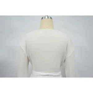 Detailed macro view of white pleated long sleeve casual top fabric texture on mannequin