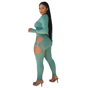Side view of sexy green ribbed jumpsuit showing decorative metal ring and hip cutout