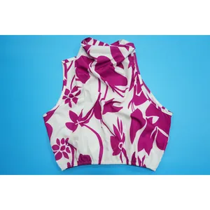 Detailed view of the white and magenta floral print sleeveless high-neck top
