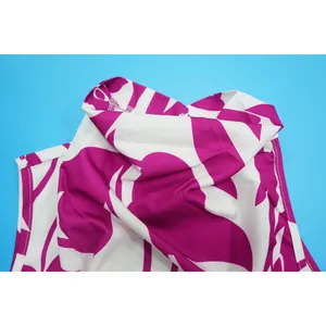 Close-up detail of purple and white floral print fabric on a stylish sleeveless outfit.