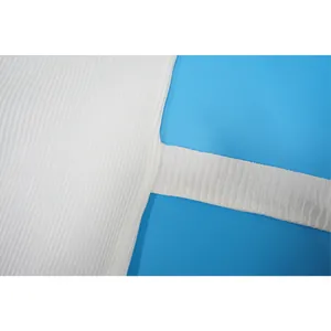 Detailed macro shot showing the crinkled pleated texture of white casual women's clothing