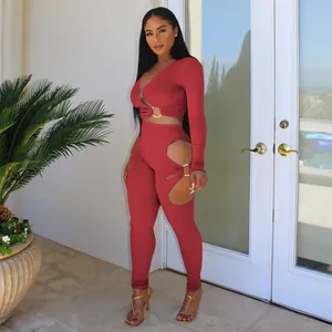 Detail view of a sexy red ribbed two-piece set with metal ring cut-out accents