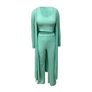 Detail view of mint green ribbed three-piece set with cardigan, top and pants