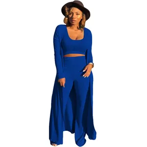 Detail of a 3-piece royal blue ribbed outfit with crop top, pants, and long cardigan.