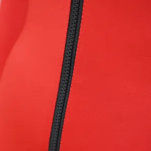 Close-up detail of a sturdy black zipper on vibrant red slim fit jumpsuit fabric