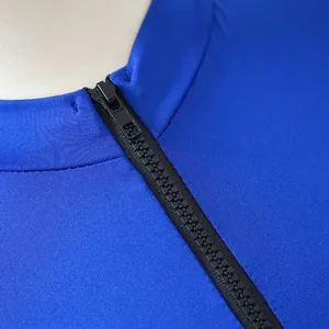 Close-up detail of a black zipper on a bright blue high-elasticity bodysuit romper