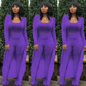 Elegant purple three-piece ribbed set with crop top, long cardigan and wide-leg pants.
