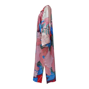 Side view of a long loose kimono windbreaker featuring a vibrant tropical leaf print pattern.