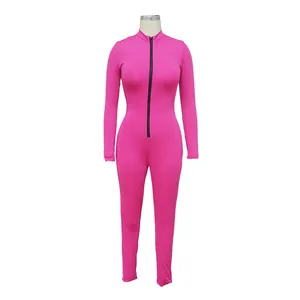 Detail view of pink long-sleeve tight jumpsuit with a functional front black zipper