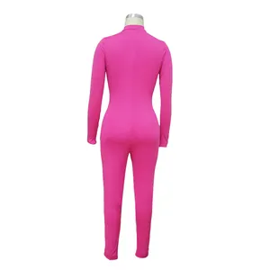 Detail view of the back of a hot pink long sleeve tight fit jumpsuit on mannequin