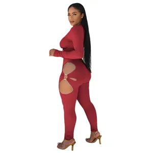 Detailed side view of the red ribbed bodycon jumpsuit showing cutout and ring detail