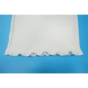 Detailed view of white pleated fabric texture with elegant lettuce edge hemline