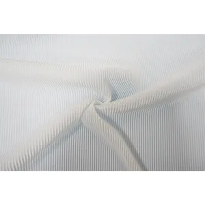 Close-up of high-quality light blue pleated fabric with fine vertical ribbing texture