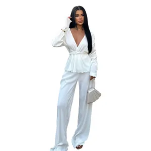 Elegant white pleated two-piece set featuring a V-neck top and wide-leg trousers.