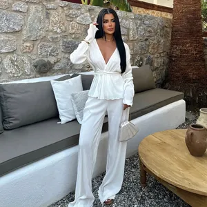 Elegant white pleated two-piece set featuring long sleeve V-neck top and wide-leg pants.