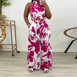 Vibrant magenta floral print two-piece set with sleeveless crop top and wide-leg pants.