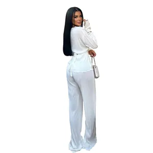 Close-up view of elegant white pleated long-sleeved leisure set with stylish waist tie