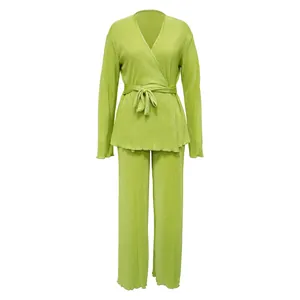 Elegant lime green pleated two-piece set with wrap top and wide-leg pants detail view