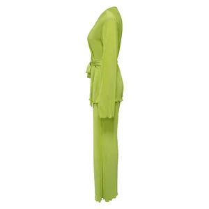 Detailed side view of a vibrant green pleated long-sleeve two-piece set for women