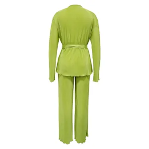 Back view of a lime green pleated two-piece set featuring long sleeves and wide-leg trousers.