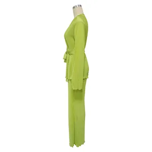 Side view of lime green pleated long sleeve top and matching pants set for women.