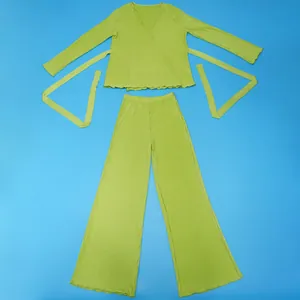 Lime green pleated two-piece set featuring long sleeve wrap top and wide leg trousers